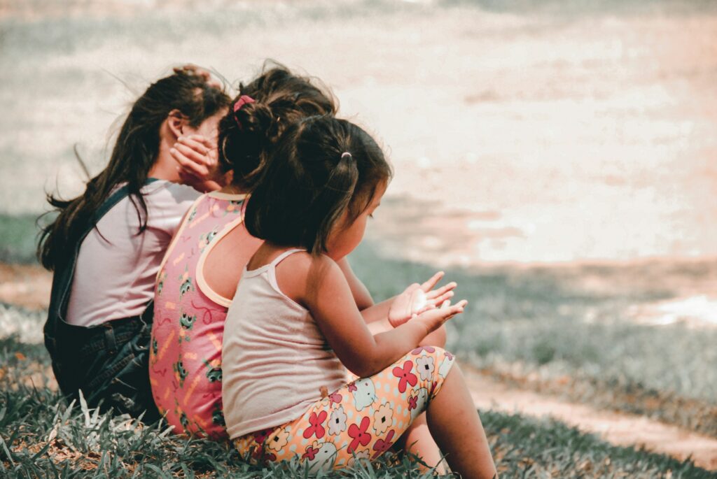 Group of young children sitting or playing together, representing different sibling roles and early childhood dynamics.