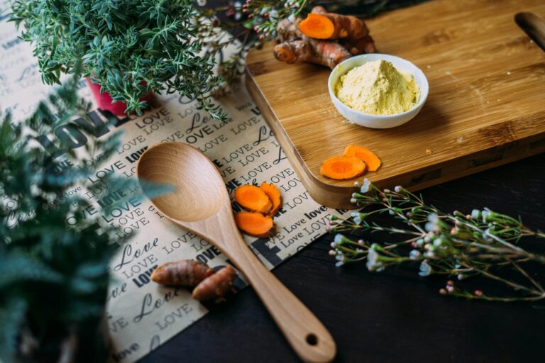 Assorted Ayurvedic herbs like turmeric, ginger, and tulsi arranged on a kitchen counter for morning wellness rituals.